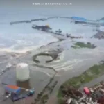 A massive tsunami wave crashing into a coastal city, illustrating the destructive power of ocean surges caused by earthquakes.