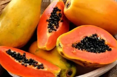 A ripe papaya sliced open, revealing its vibrant orange flesh—though not everyone can enjoy its benefits.