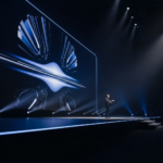 A high-tech stage at Apple Park showing the iOS 27 logo and a vibrant, flowing Siri animation symbolizing generative AI.