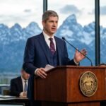 Federal Reserve Chair Kevin Warsh speaking at the podium during the Jackson Hole Economic Symposium.