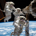 NASA astronauts Anil Menon and Jessica Meir performing complex maintenance and solar array upgrades outside the International Space Station during a spacewalk.