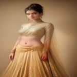 A high-fashion, glamorous portrait of Indian actress Triptii Dimri posing in a luxury studio setting with elegant lighting.
