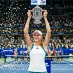 Elena Rybakina triumphantly holds the 2026 US Open trophy at Arthur Ashe Stadium after becoming world No. 1.