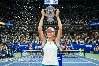 Elena Rybakina triumphantly holds the 2026 US Open trophy at Arthur Ashe Stadium after becoming world No. 1.