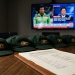 A composite image showing the iconic green baggy cap of Australian cricket alongside a portrait of a concerned Imran Khan, symbolizing the intersection of sport and politics.