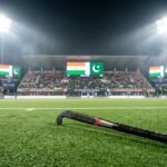 A high-stakes hockey match atmosphere with flags of India and Pakistan, illustrating the diplomatic tension in Asian sports governance.