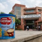 A legal gavel resting next to a container of infant formula, symbolizing the FSSAI's legal action against Nestle India.