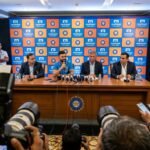 Muthoot Fincorp logo and BCCI logo displayed together at an official press conference announcing the home season title sponsorship deal.