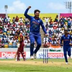 Kuldeep Yadav celebrates a wicket during the match against West Indies with teammates cheering.