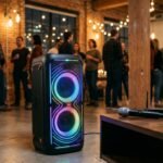 A professional press photo showcasing the JBL PartyBox 720 speaker with its 800W dual woofers illuminated by vibrant RGB lights in a party setting.