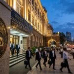A photorealistic view of the Reserve Bank of India headquarters in Mumbai during a sunset, reflecting the gravity of the financial district.