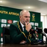South Africa cricket coach Shukri Conrad speaking at a press conference with a serious expression after the Durban Test match.