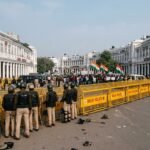 Heavy Delhi Police presence and yellow barricades at Connaught Place during the anti-CEC Tiranga protest.