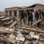 Grieving families and rescue workers at the site of a collapsed school building in Pakistan, where 33 students died.
