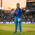 Smriti Mandhana wearing the Indian national team blazer, standing confidently at a press conference discussing her leadership philosophy.