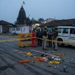 Emergency services and police at the site of a fatal truck accident near a temple in Madhya Pradesh where 12 people died.