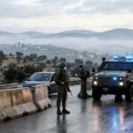 Israeli soldiers and military vehicles stationed at a reinforced checkpoint in the West Bank during a high-alert security lockdown before the elections.