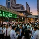 Indian stock market indices Sensex and Nifty showing record high points on a digital trading screen with green indicators.