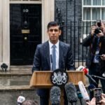UK Prime Minister Rishi Sunak announces a snap general election on July 4, 2024, standing in the rain outside 10 Downing Street.
