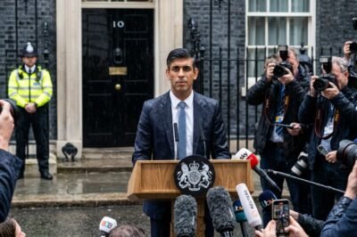 UK Prime Minister Rishi Sunak announces a snap general election on July 4, 2024, standing in the rain outside 10 Downing Street.