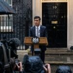 Rishi Sunak standing at a lectern outside 10 Downing Street in the rain, announcing the July 4 general election.
