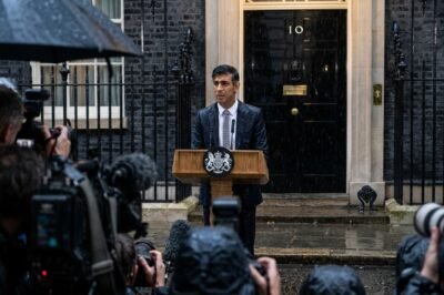 Rishi Sunak standing at a lectern outside 10 Downing Street in the rain, announcing the July 4 general election.