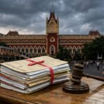 A legal gavel on a desk in front of the Calcutta High Court building, symbolizing the landmark OBC reservation ruling.